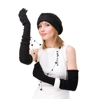 knitwear. woman wearing a winter cap and gloves with black necklace against isolated white background