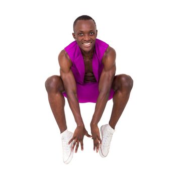 Happy young man jumping against isolated white background