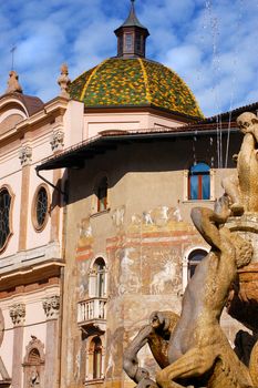 Frescoed building - Fountain of Neptune and octagonal dome in Trento Italy