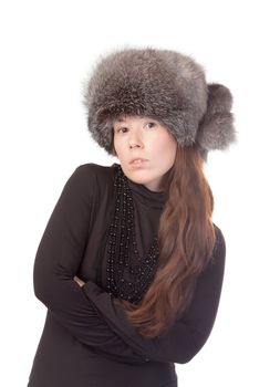 Vivacious woman in a winter outfit with a fur hat on white background