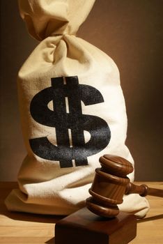 A bag of money and gavel represent many legal expenses.