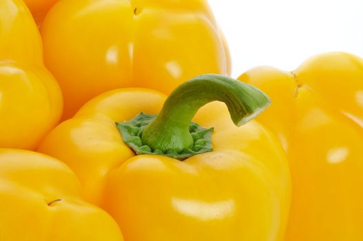 Perfect Raw Yellow Bell Peppers with Stem closeup on white background