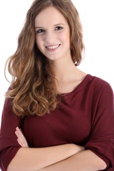 Beautiful smiling teenage girl with long curly hair standing with her arms folded facing the camera isolated on white