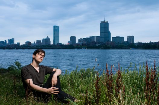 Young man at edge of the Charles River, Boston