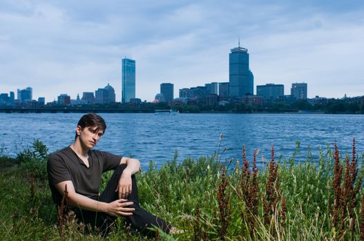 Young man at edge of the Charles River, Boston