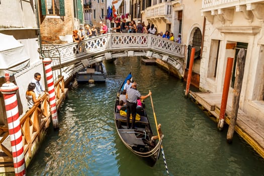 16. Jul 2012 - Tourists on gondolas at canal in Venice, Italy 