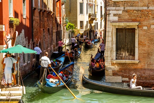 16. Jul 2012 - Tourists on gondolas at canal in Venice, Italy 