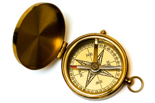 Old style brass compass on white background