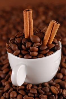 Coffee beans with cinnamon and white cup