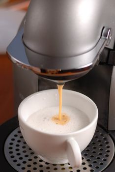 Making cappuccino with coffee machine