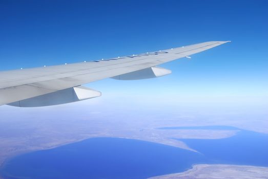 Plane wing against blue sky