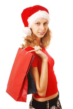 Girl in Santa's hat with bags, isolated on white