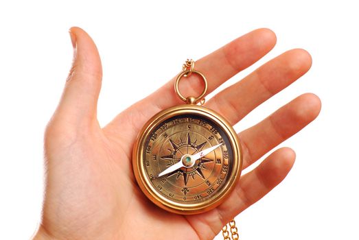 Antique brass compass in hand isolated on white