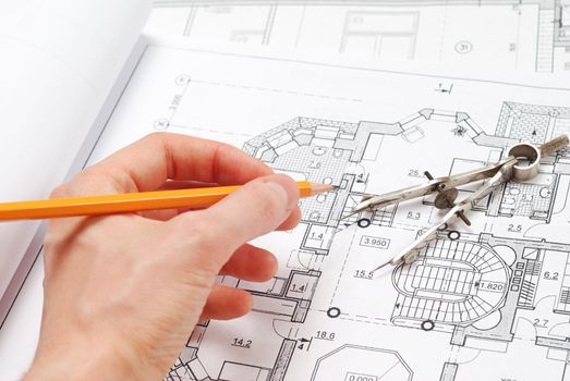 House plan blueprints, designer's hand