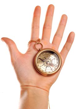 Antique brass compass in hand isolated on white