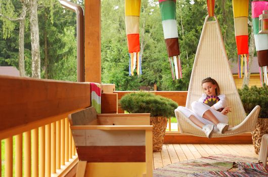 Girl relaxing on the porch 