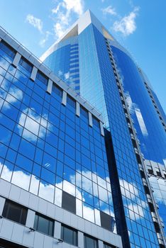 Modern office building with sky reflection in windows