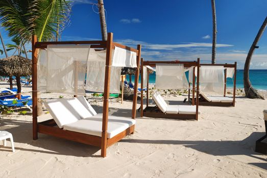 Luxury wooden chaise lounge on beautiful caribbean beach in Dominican Republic