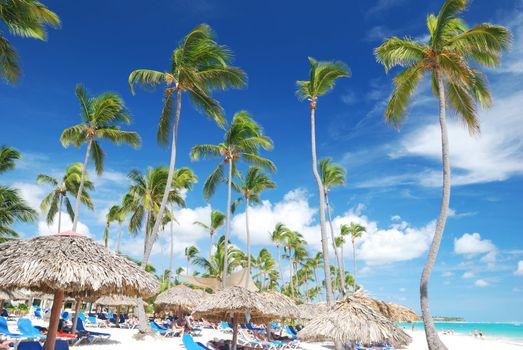Beautiful caribbean beach with chaise lounge in Dominican Republic