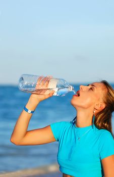 Woman drinking water after jogging
