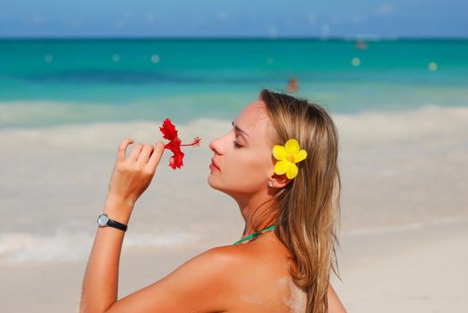 Girl with flower on caribbean beach