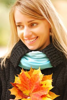 Girl with yellow autumn leaves