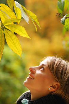 Girl with yellow autumn leaves