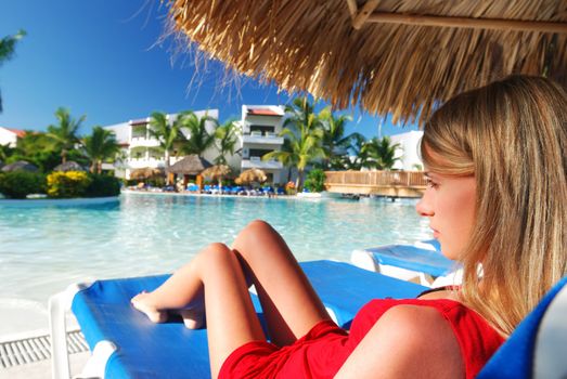 Girl near resort swimming pool