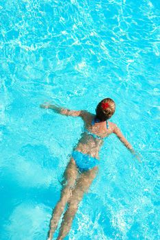 Girl in resort swimming pool