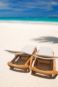 Beautiful caribbean beach with chaise lounge in Dominican Republic