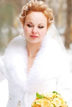 Bride holding bouquet of yellow roses