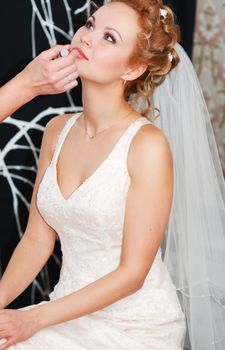 Bride having her makeup applied