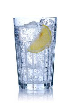 Water glass with ice & lemon isolated on white. Soft reflection.