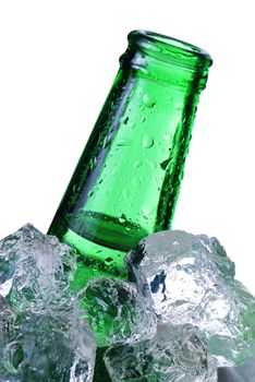 Green beer bottle in ice isolated on white