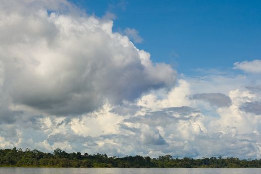 Rainforest and cloudy sky over the Amazon River, Peru