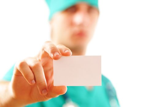 Doctor holding blank business card. Shallow DOF.
