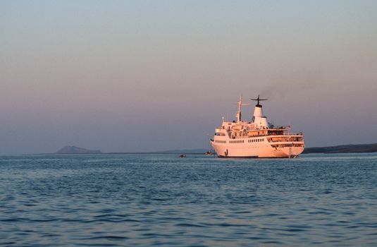 Cruise ship at anchor at sunset in Ecuador