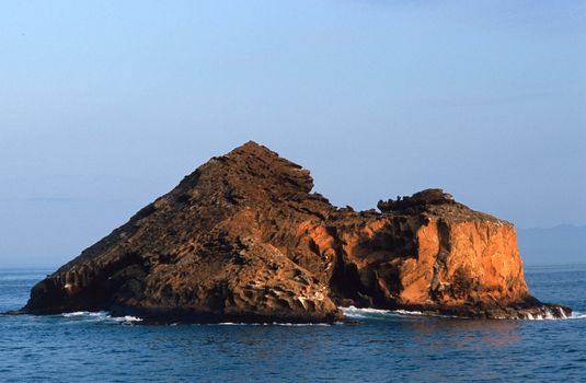 Rocky red island off the Galapagos Islands