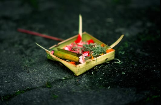 Balinese Hindu offering on the ground in Ubud, Bali