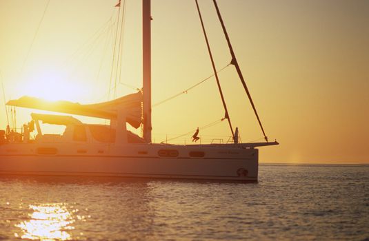 Jumping boy on the deck of a sailboat