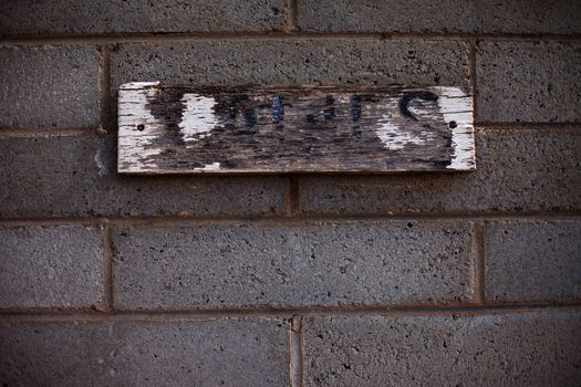 Worn and weathered ladies' room sign in rural Australia