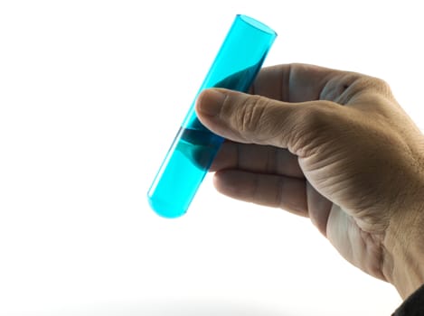 hand with liquid in glass tube