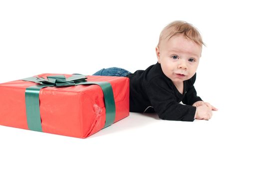 Baby boy with christmas present on white