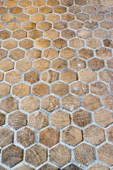 elaborated old wooden floor made of wooden hexagon tiles and concrete