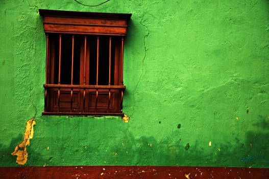 An old green colonial wall in the historic center of Bogota, Colombia.