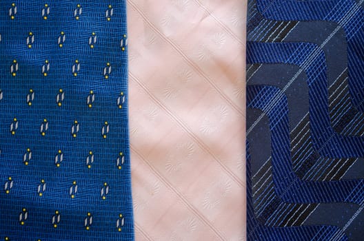 Three cravat tie scarfs texture pattern background. Blue and pink material fashion sewings.