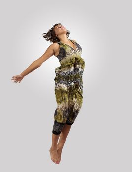 pretty modern slim hip-hop style woman jumping dancing on a colour background