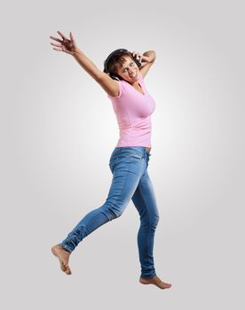 pretty modern slim hip-hop style woman jumping dancing on a grey background