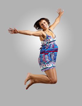 pretty modern slim hip-hop style woman jumping dancing on a colour background