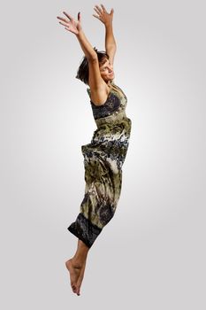 pretty modern slim hip-hop style woman jumping dancing on a colour background